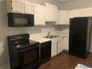 3317 Waverly Boulevard, Unit B Richmond, VA 23222 - Photo 13 of 36 a kitchen with a sink stove and microwave