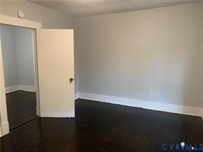 3317 Waverly Boulevard, Unit B Richmond, VA 23222 - Photo 25 of 36 an empty room with wooden floor and windows