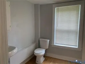a bathroom with a sink toilet and a mirror