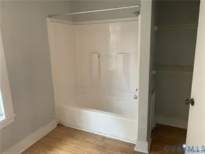 a bathroom with a shower and a bath tub