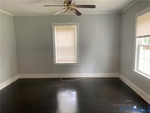 3317 Waverly Boulevard, Unit B Richmond, VA 23222 - Photo 4 of 36 an empty room with wooden floor windows and window