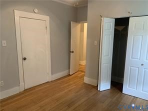 3317 Waverly Boulevard, Unit B Richmond, VA 23222 - Photo 9 of 36 an empty room with wooden floor and closet area