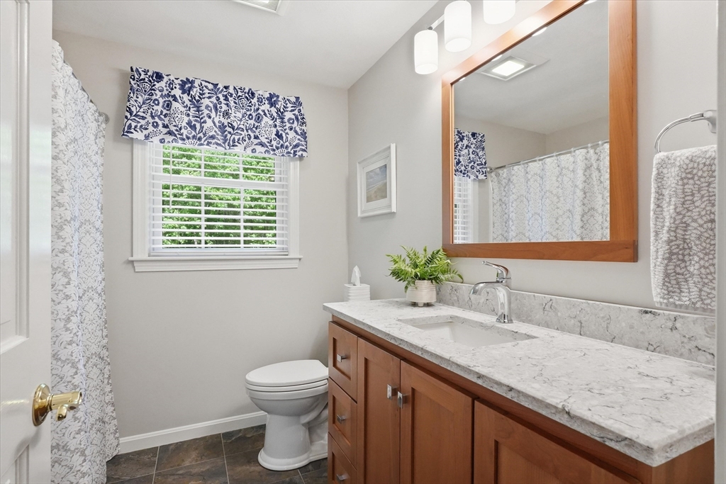 9 Fazio Farm Road Georgetown, MA 01833 - Photo 26 of 42 a bathroom with a granite countertop sink a toilet and a mirror