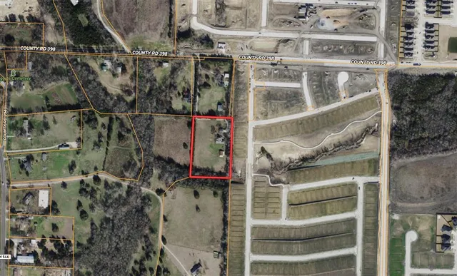 an aerial view of a residential apartment building with a yard