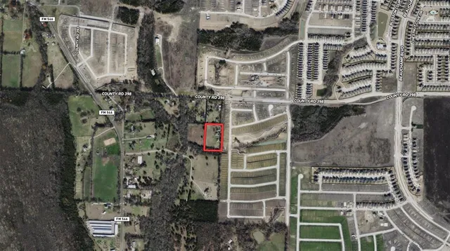 a aerial view of a residential apartment building with a yard