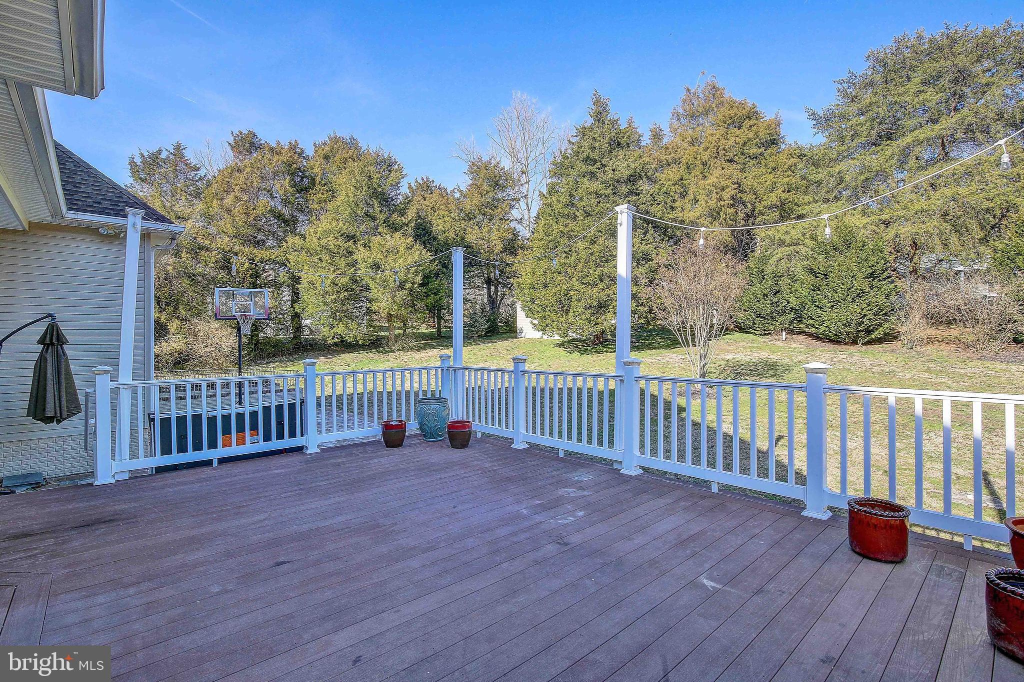 3300 Holland Cliffs Road Huntingtown, MD 20639 - Photo 12 of 93 a view of a deck with a floor to ceiling window and wooden fence