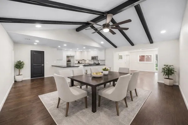 a dining room with furniture and wooden floor