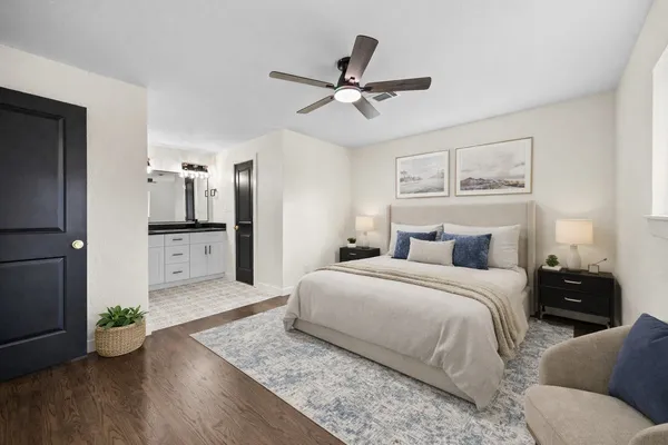 a bedroom with a bed and ceiling fan