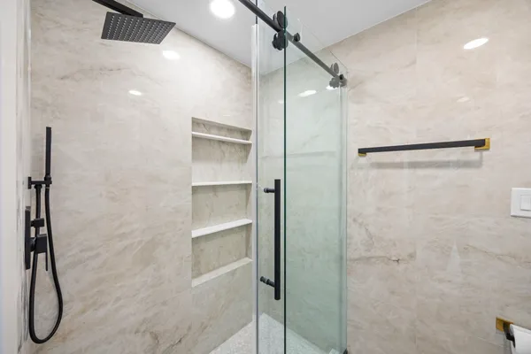 a bathroom with a shower and a glass door