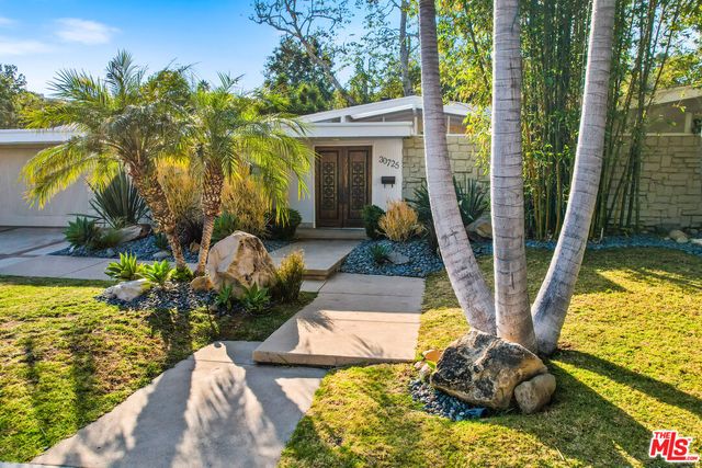 a view of backyard with swimming pool and outdoor seating
