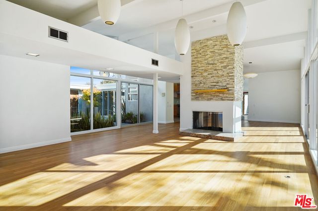 a view of an empty room with glass door