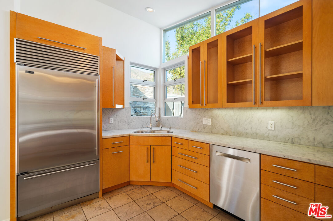 30725 Manzano Drive Malibu, CA 90265 - Photo 20 of 51 a kitchen with stainless steel appliances granite countertop a sink and cabinets