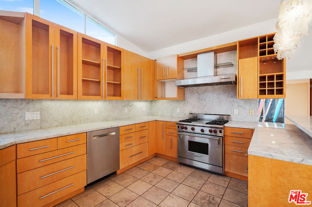 30725 Manzano Drive Malibu, CA 90265 - Photo 21 of 51 a kitchen with stainless steel appliances granite countertop a stove sink and cabinets