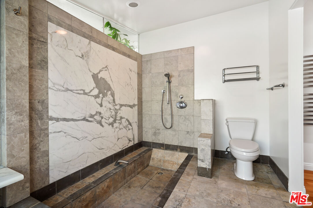30725 Manzano Drive Malibu, CA 90265 - Photo 31 of 51 a bathroom with a granite countertop toilet a shower and a mirror