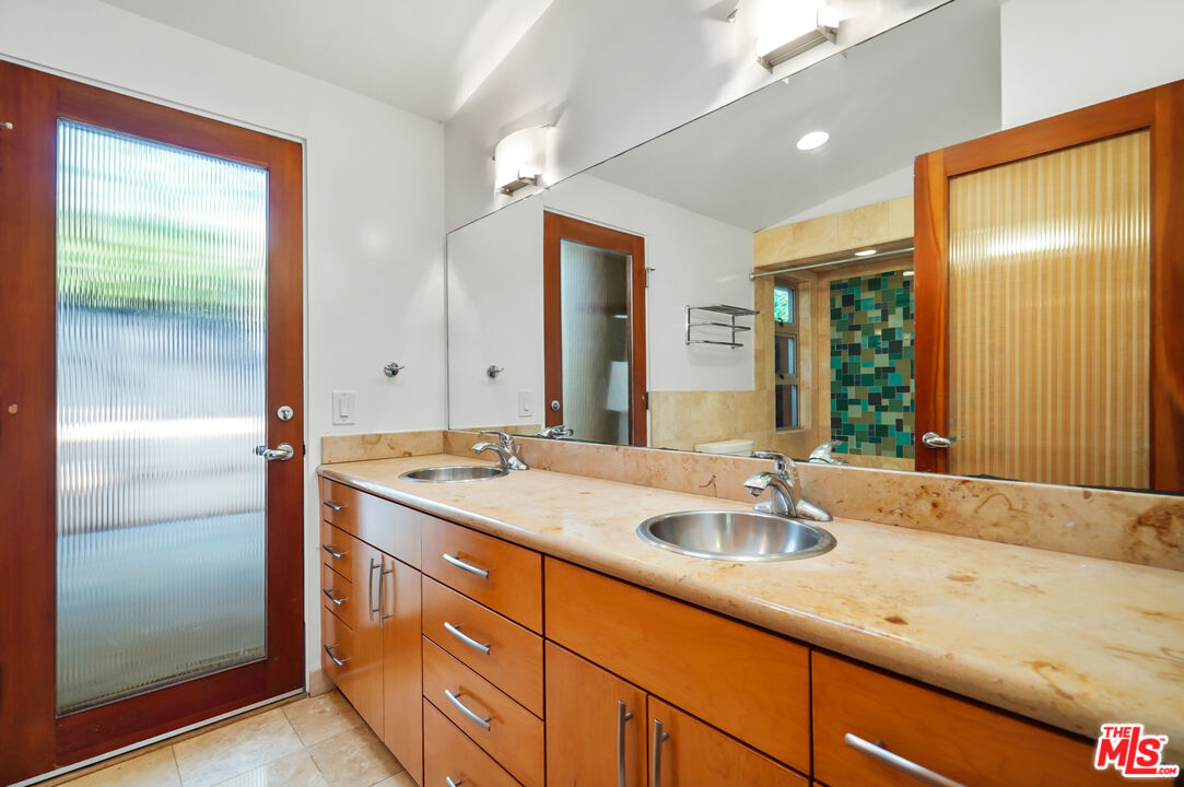 30725 Manzano Drive Malibu, CA 90265 - Photo 36 of 51 a bathroom with a sink and a mirror