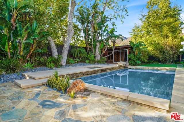a view of a swimming pool with a patio