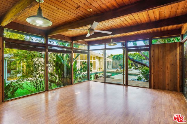 a view of room with wooden floor and balcony