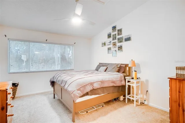 a bed sitting in a bedroom next to a window