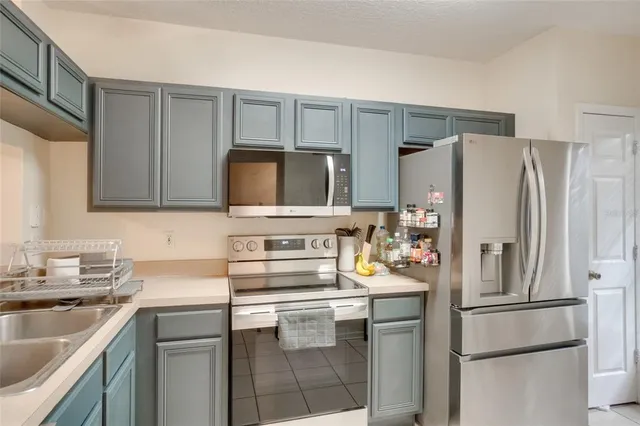 a kitchen with a refrigerator sink and microwave