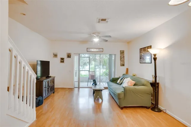a living room with furniture and a wooden floor