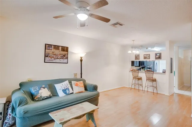 a living room with furniture and kitchen view