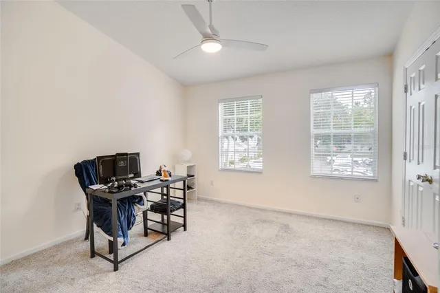 a view of a workspace with furniture and a window