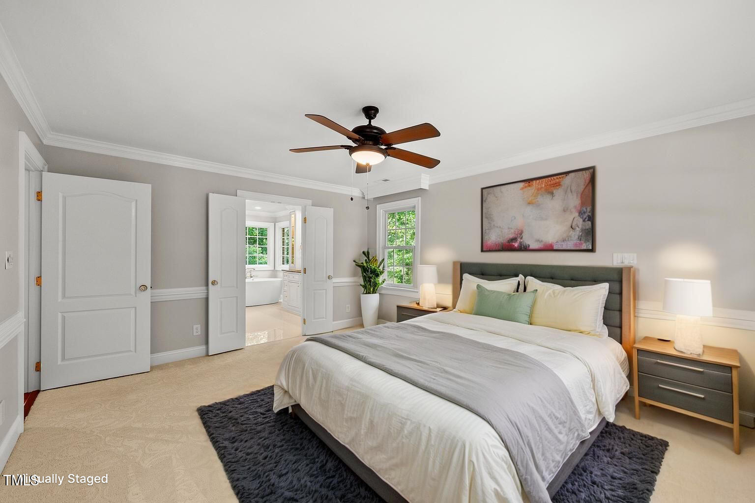 10825 Rondeau Woods Court Raleigh, NC 27614 - Photo 21 of 65 a bedroom with a large bed and a chandelier