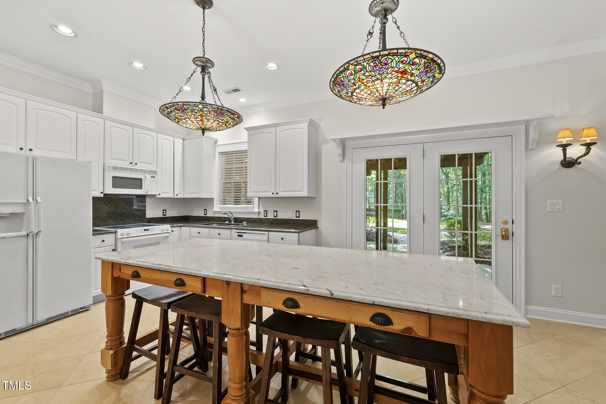 10825 Rondeau Woods Court Raleigh, NC 27614 - Photo 42 of 65 a kitchen with stainless steel appliances granite countertop a dining table chairs refrigerator and cabinets