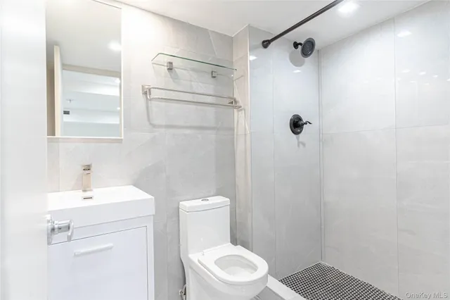 a white toilet sitting next to a bathroom sink