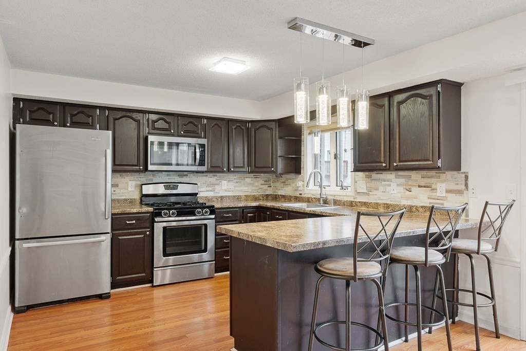 25 Century Way, Unit 25 Gardner, MA 01440 - Photo 18 of 34 a kitchen with stainless steel appliances granite countertop a stove top oven a sink and dishwasher
