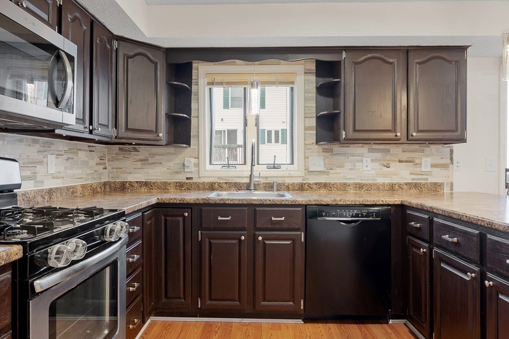 25 Century Way, Unit 25 Gardner, MA 01440 - Photo 20 of 34 a kitchen with granite countertop a stove sink and cabinets