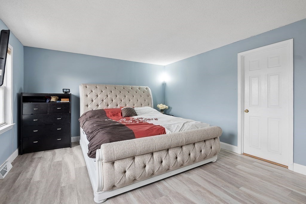 25 Century Way, Unit 25 Gardner, MA 01440 - Photo 23 of 34 a bedroom with a bed and a dresser