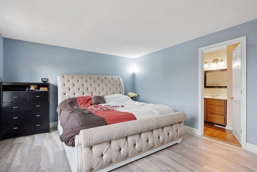 25 Century Way, Unit 25 Gardner, MA 01440 - Photo 24 of 34 a bedroom with a bed and a closet