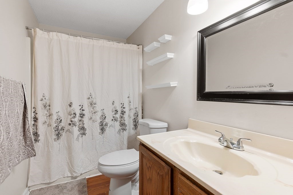 25 Century Way, Unit 25 Gardner, MA 01440 - Photo 25 of 34 a bathroom with a sink vanity mirror and toilet