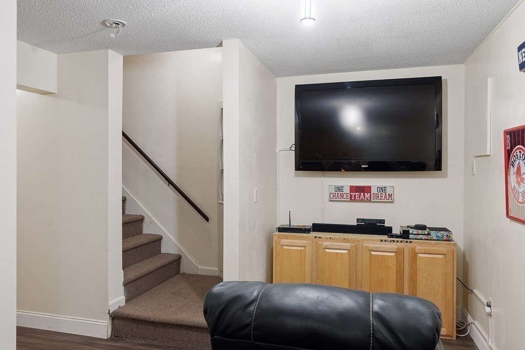 25 Century Way, Unit 25 Gardner, MA 01440 - Photo 32 of 34 a living room with furniture and a flat screen tv