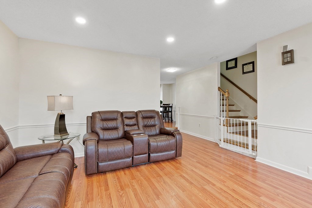 25 Century Way, Unit 25 Gardner, MA 01440 - Photo 7 of 34 a living room with furniture and a wooden floor