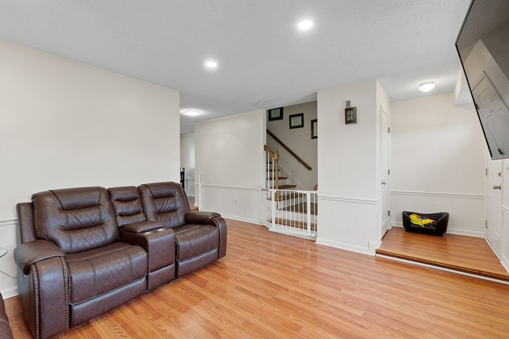 25 Century Way, Unit 25 Gardner, MA 01440 - Photo 8 of 34 a living room with furniture and a wooden floor