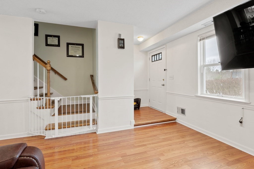 25 Century Way, Unit 25 Gardner, MA 01440 - Photo 9 of 34 a view of a livingroom with wooden floor and staircase