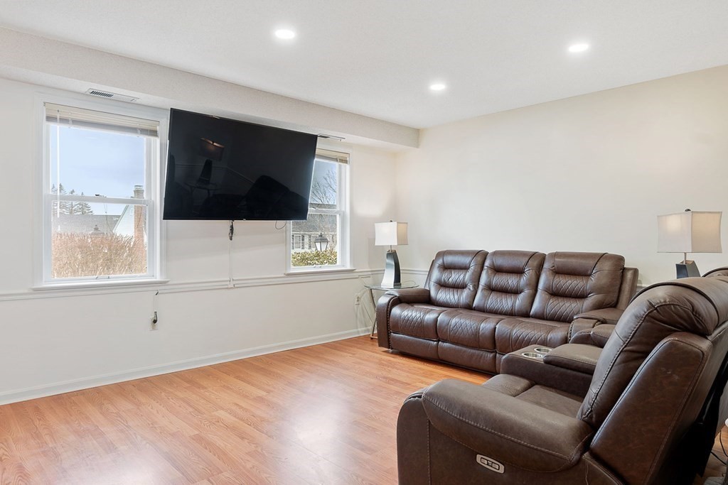 25 Century Way, Unit 25 Gardner, MA 01440 - Photo 10 of 34 a living room with furniture and a flat screen tv