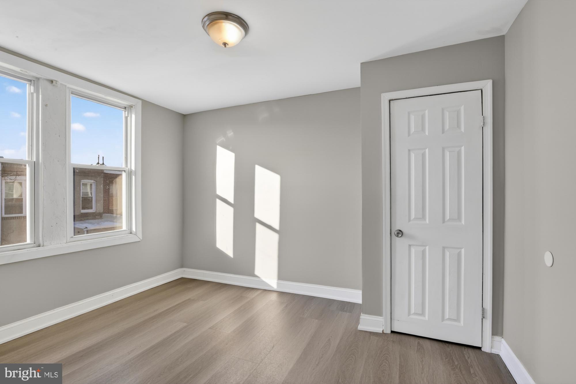 1640 South 28th Street Philadelphia, PA 19145 - Photo 16 of 27 an empty room with wooden floor and windows