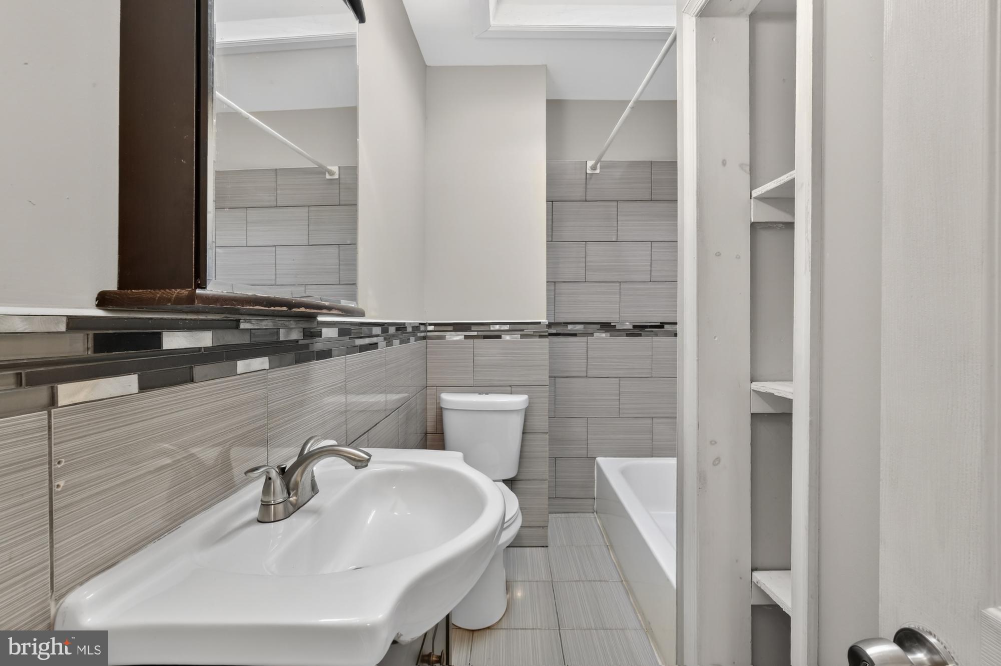 1640 South 28th Street Philadelphia, PA 19145 - Photo 19 of 27 a bathroom with a sink and a mirror