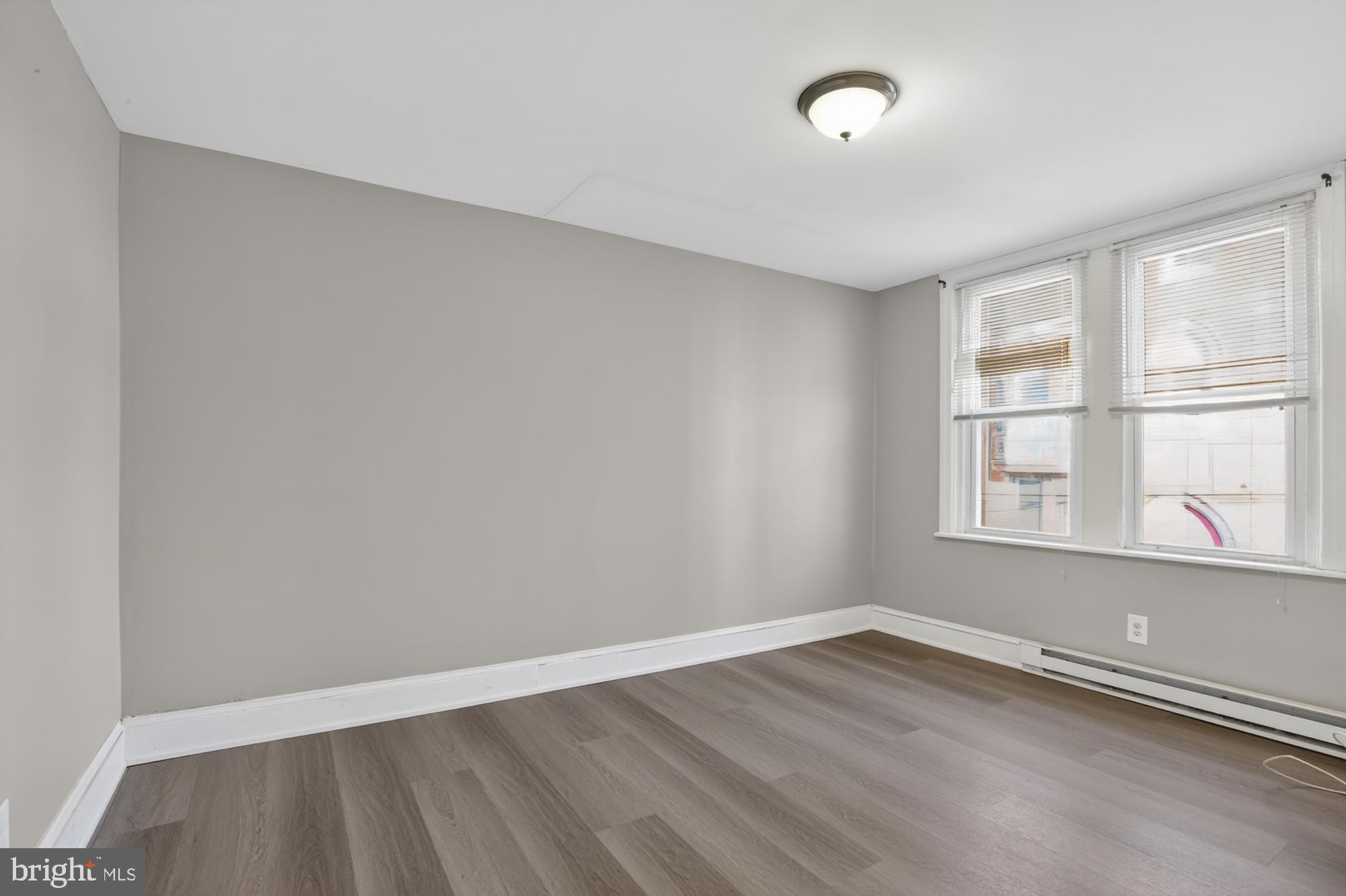 1640 South 28th Street Philadelphia, PA 19145 - Photo 20 of 27 an empty room with wooden floor and windows