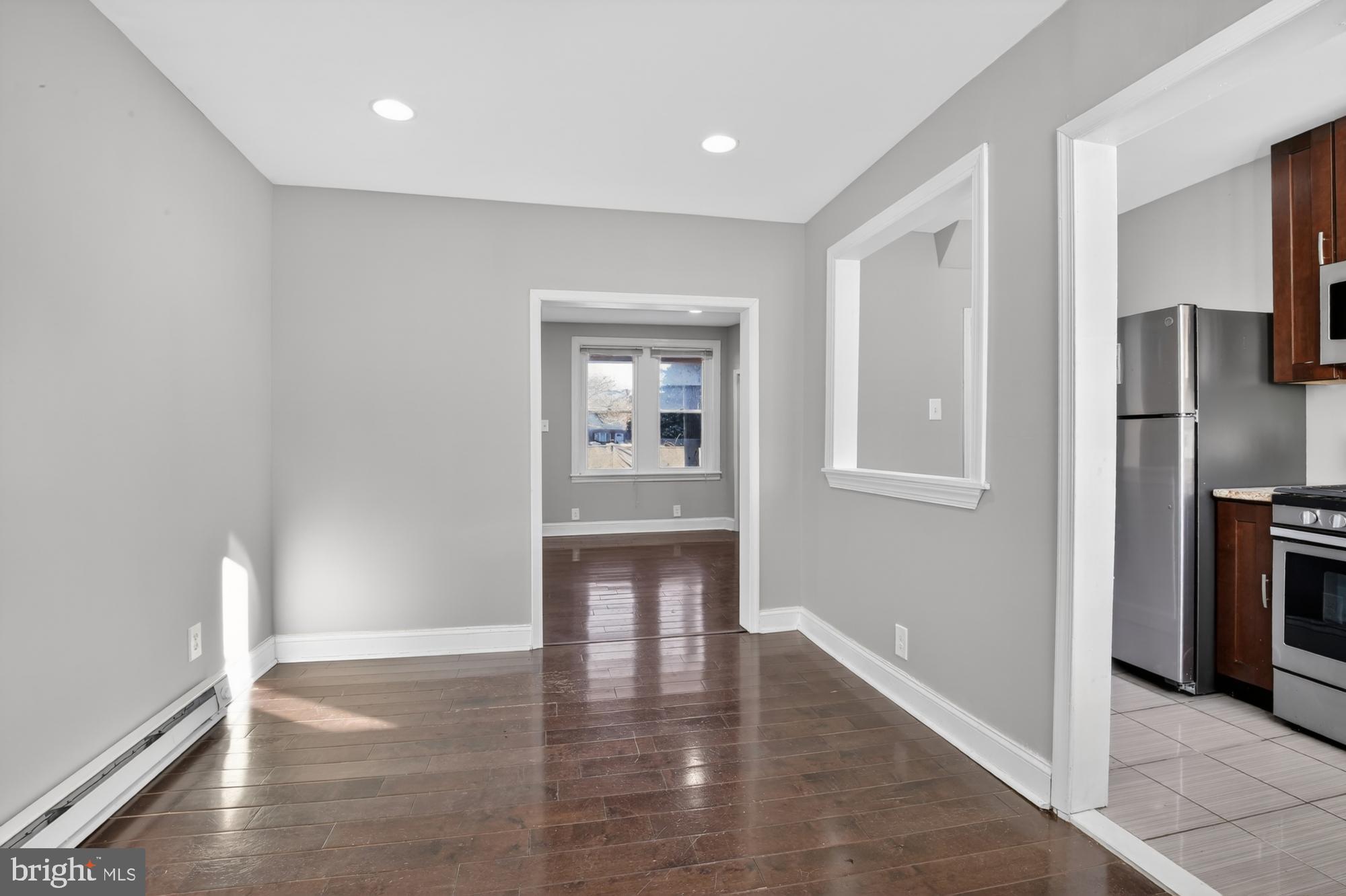 1640 South 28th Street Philadelphia, PA 19145 - Photo 6 of 27 a view of an empty room with wooden floor and a window