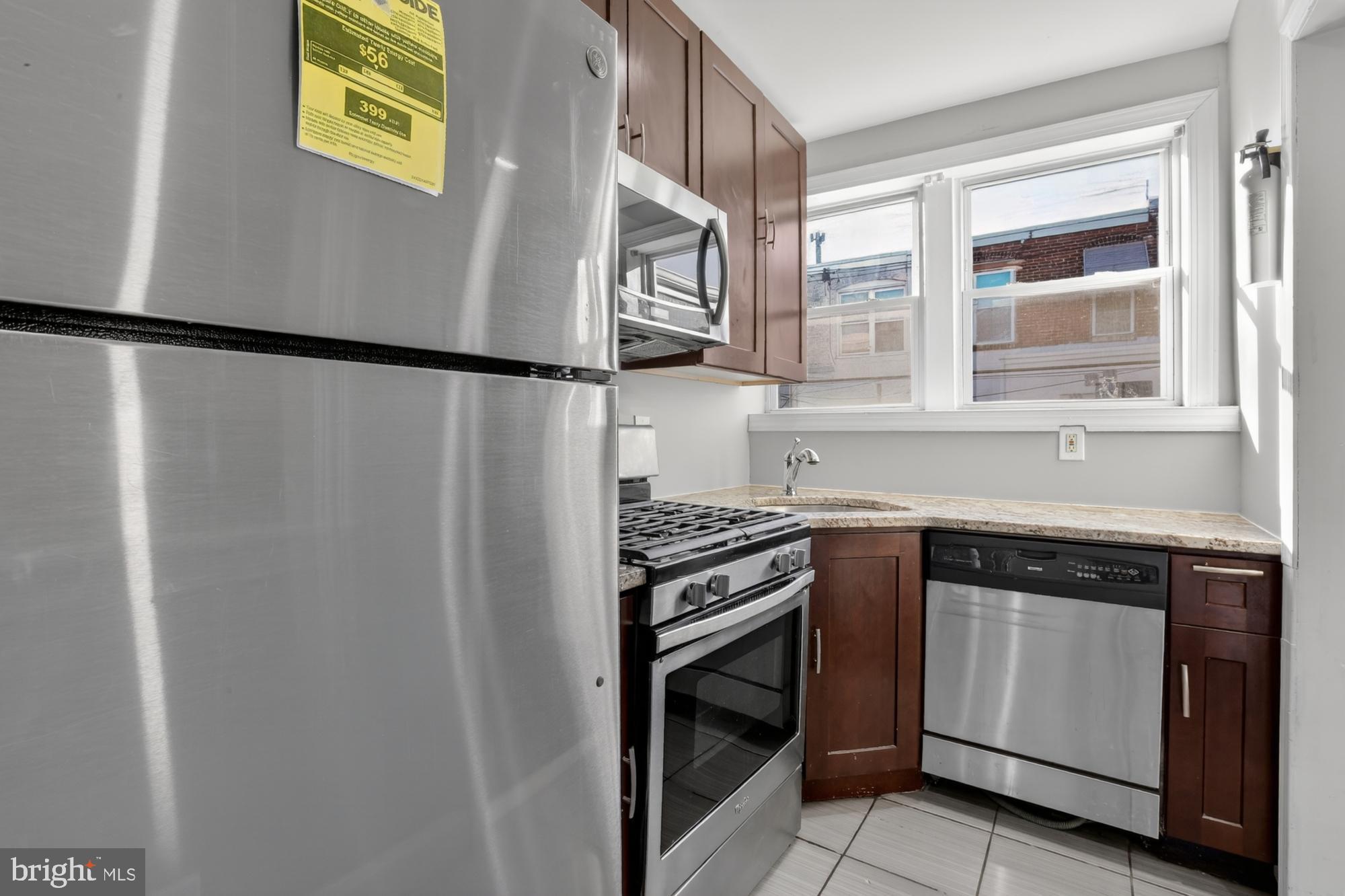 1640 South 28th Street Philadelphia, PA 19145 - Photo 8 of 27 a kitchen with stainless steel appliances granite countertop a stove and a sink