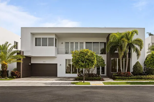 a view of a house with a yard and a garage