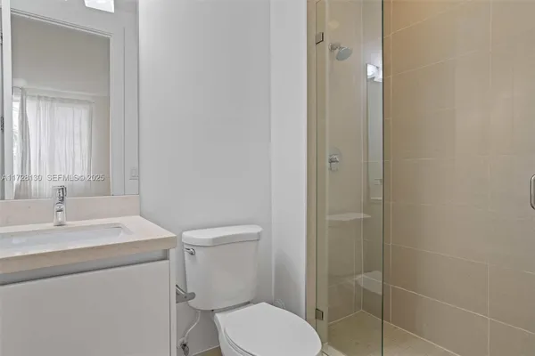 a bathroom with a toilet sink shower and mirror