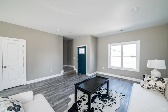 a living room with furniture and wooden floor