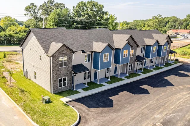 an aerial view of a house with a swimming pool