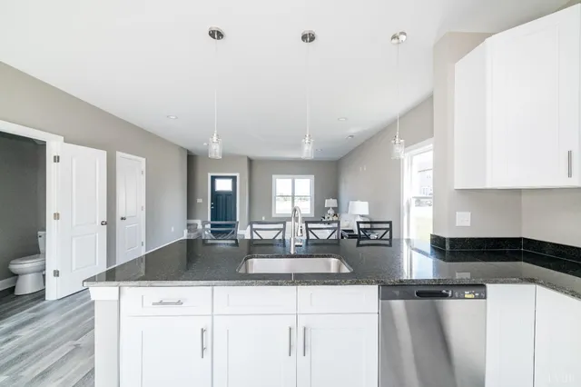 a kitchen with sink refrigerator and cabinets