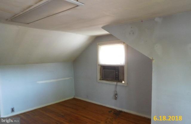 1234 Hillside Road Pasadena, MD 21122 - Photo 3 of 12 a view of an empty room with wooden floor and a window